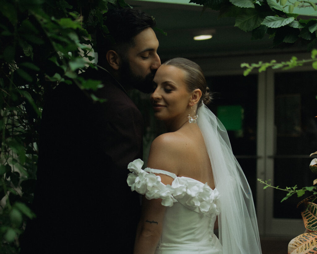 bride and groom kissing in garden. garden wedding 